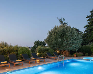 Vederi Estate Villa Melpomeni pool and terrace lit up at dusk