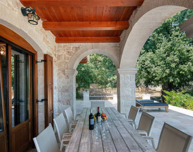 Vederi Estate Villa Melpomeni terrace with outdoor decorated table and chairs