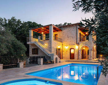 Vederi Estate Villa Melpomeni the villa lit up at dusk