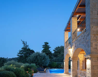 Vederi Estate Villa Melpomeni exterior lit up at dusk