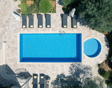 Vederi Estate Villa Melpomeni top-down view of the pools and sunbeds